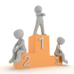 Three gray stick figures on an orange podium showing 1st, 2nd, and 3rd place winners, with the champion standing tall on top