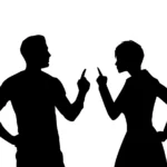 Two people in silhouette facing each other with pointing fingers raised, appearing to argue or disagree