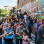 many people painting a mural together